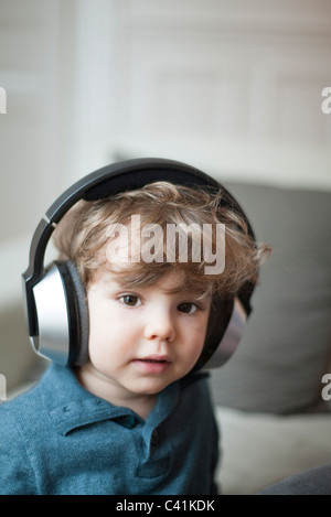 Toddler boy wearing headphones, portrait Stock Photo