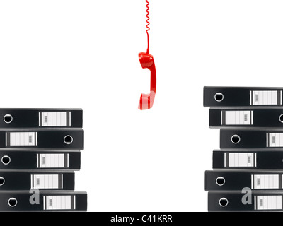 A4 lever arch folders and a phone handset isolated against a white background Stock Photo