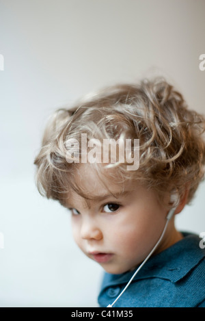Toddler boy wearing earphones, portrait Stock Photo