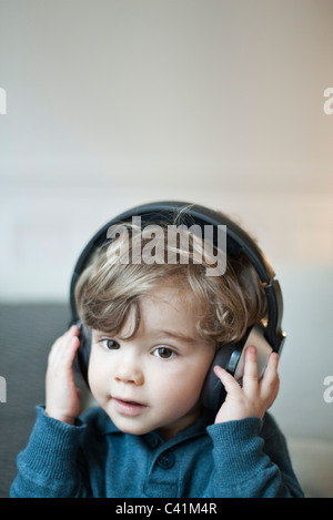 Toddler boy wearing headphones, portrait Stock Photo