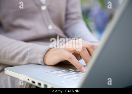 Woman using laptop computer, cropped Stock Photo