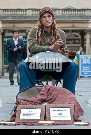 A musician playing the instrument called the Hang, which originates from Switzerland on the streets of Bath. Stock Photo