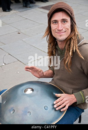 A musician playing the instrument called the Hang, which originates from Switzerland on the streets of Bath. Stock Photo