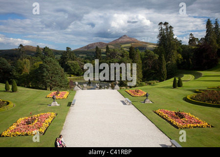 Great Sugarloaf Mountain rises above the gardens of Powerscourt House, Enniskerry, County Wicklow, Ireland. Stock Photo