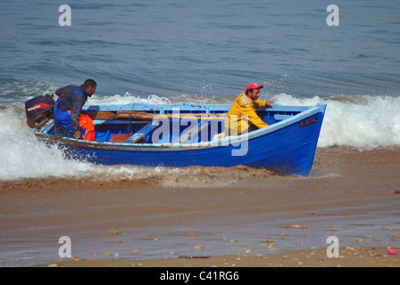 Fishing boat coming ashore in Taghazout, morocco Stock Photo