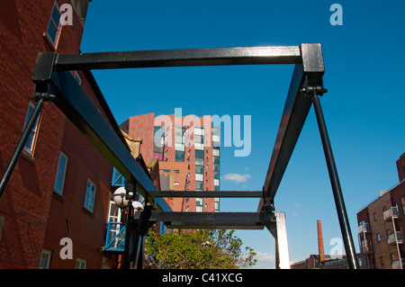 Islington Wharf apartment block, New Islington, Manchester, England, UK. Through a small bascule bridge at Piccadilly Village. Stock Photo