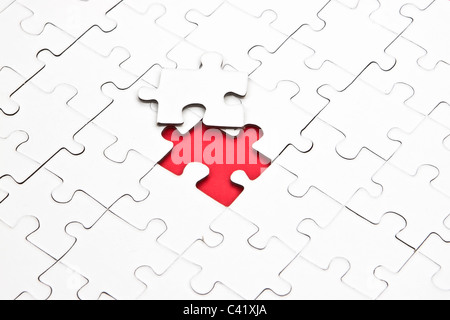 a puzzle with missing parts, which are connected Stock Photo