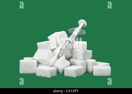 sugar cubes with an syringe as a symbol for diabetes Stock Photo