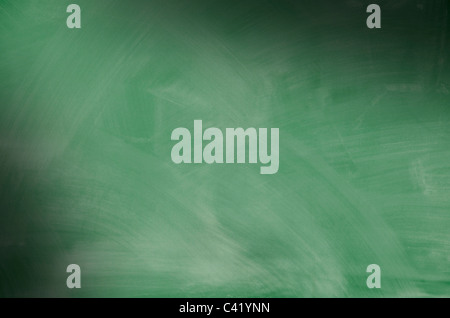 Green chalkboard with smeared chalk eraser marks lit diagonally Stock Photo
