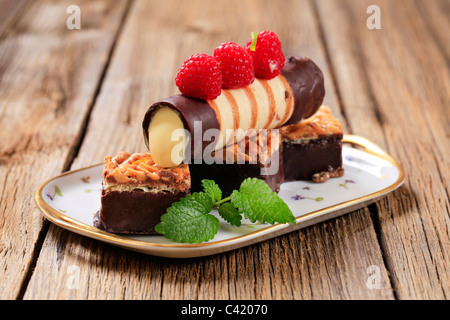 Chocolate dipped wafer cookies and custard filled pastry tube Stock Photo