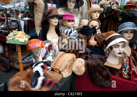 Vintage hats on mannequins and fur for sale on a Portobello Road Market stall in Notting Hill Gate, London England  KATHY DEWITT Stock Photo