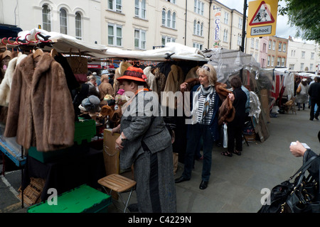 Fur coats and jackets for sale on a Portobello Road market stall Notting Hill London England UK Stock Photo