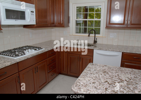 New cherry cabinets, granite counter tops, and ceramic tile floor highlight kitchen remodeling job in Massachusetts home. Stock Photo