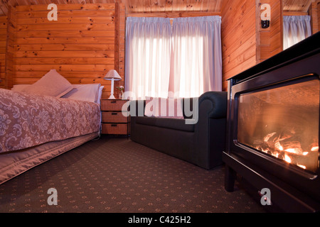 Nice warm interior of mountain lodge apartment with detail of fireplace. Stock Photo