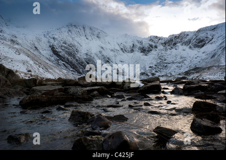 A winter scene of Cwm Idwal taken from the stream leaving Llyn Idwal Stock Photo