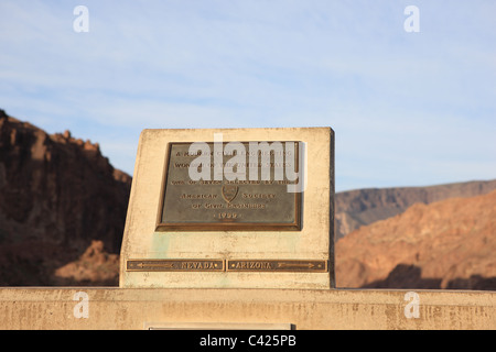 Plaque at the Hoover Dam which marks the state line between Nevada (to the left) and Arizona (to the right). Stock Photo