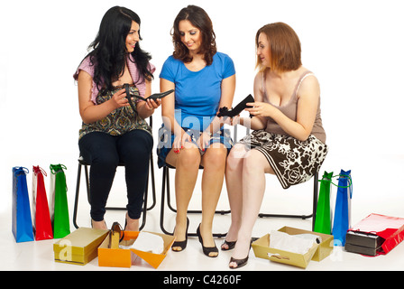 Happy women shopping shes and having conversation in a shop center against white background Stock Photo