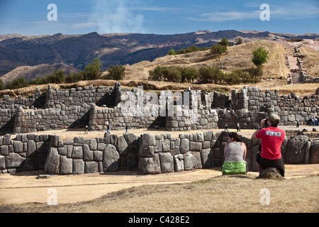 Peru, Cusco, Cuzco, Saqsayhuaman, Sacsayhuaman, Sacsaywaman. Inca Ruins. Tourists. Man and woman. UNESCO World Heritage Site. Stock Photo