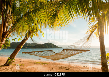 Hammock on beach at Matangi Private Island Resort, Fiji. Stock Photo