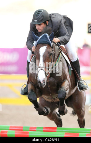 Mohamed Abdalla of Egypt riding BUZZWORD 2010 Singapore Youth Olympic Games Equestrian Jumping Individual Round B. Stock Photo