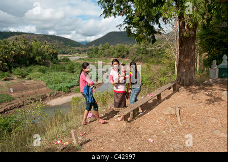 A Lao family on the river bank in Luang Prabang the old Royal capital of Laos people's Democratic of Laos Stock Photo