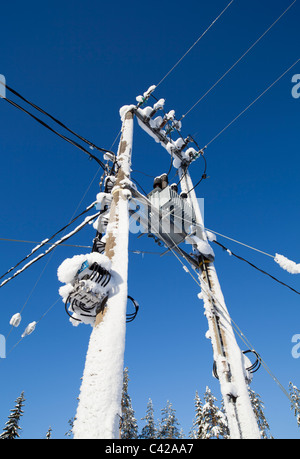 Snow covered step-down transformer from 110 kilovolts to 220-240 Volts , Finland Stock Photo