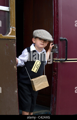 World War II, Second World War, 'WWII', 'WW2' child refugee & evacuees, warfare, human, persons, poster, sign, emigrant, departure, suffering, escape, help, war, people in crisis,   Re-enactment at a British Railway Station. The 1940, 1941, 1942, 1943, 1944,s  World War Two Wartime Weekend actors at Rawtenstall Station, Lancashire, May 2011 Stock Photo