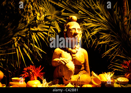 Statue of Ixchel, a Mayan fertility and moon goddess, surrounded by offerings, Xcaret park, Riviera Maya, Quintana Roo, Mexico Stock Photo