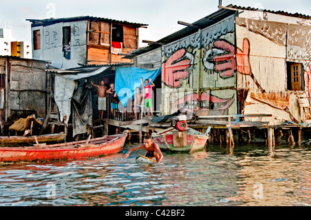 Palafitas or Stilt dwellers living and fishing on the river that flows through Recife in Northeastern Brazil. Stock Photo