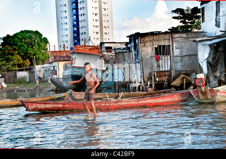 Palafitas or Stilt dwellers living and fishing on the river that flows through Recife in Northeastern Brazil. Stock Photo