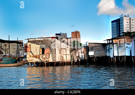 Palafitas or Stilt dwellers living and fishing on the river that flows through Recife in Northeastern Brazil. Stock Photo