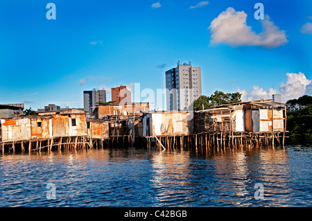 Palafitas or Stilt dwellers living and fishing on the river that flows through Recife in Northeastern Brazil. Stock Photo