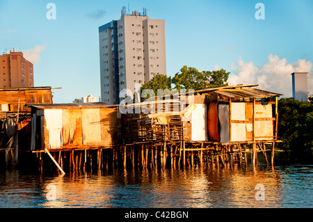 Palafitas or Stilt dwellers living and fishing on the river that flows through Recife in Northeastern Brazil. Stock Photo