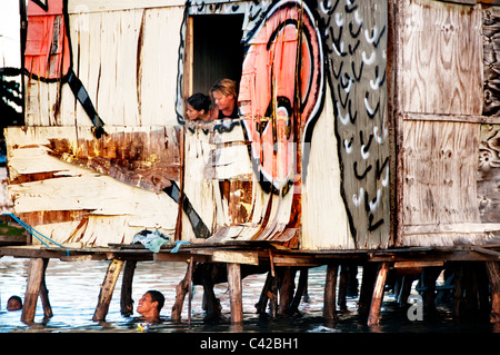 Palafitas or Stilt dwellers living and fishing on the river that flows through Recife in Northeastern Brazil. Stock Photo