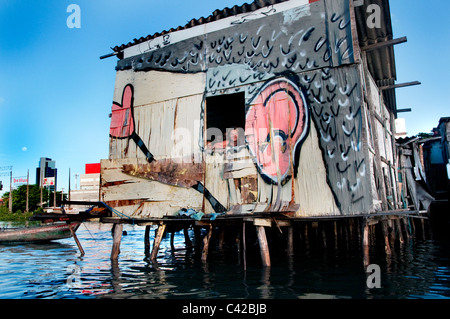 Palafitas or Stilt dwellers living and fishing on the river that flows through Recife in Northeastern Brazil. Stock Photo