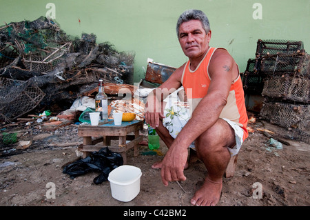 Palafitas or Stilt dwellers living and fishing on the river that flows through Recife in Northeastern Brazil. Stock Photo