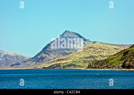 Imposing mountain Blabheinn (Blaven) On Skye in Scotland viewed from Loch Scavaig with Camasunary left Stock Photo