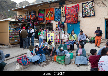 Peru, Ollantaytambo, People drinking chicha, the Indian beer made of mais, on main square. Stock Photo