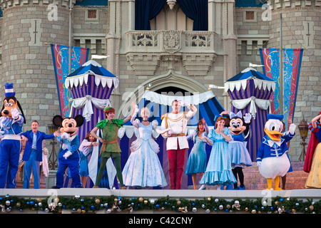 Show at Cinderella's castle features many Disney characters in costume at the Magic Kingdom in Disney World, Kissimmee, Florida Stock Photo