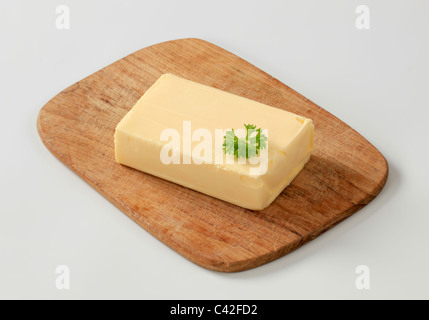 Block of fresh butter on a cutting board Stock Photo