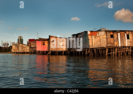 Palafitas or Stilt dwellers living and fishing on the river that flows through Recife in Northeastern Brazil. Stock Photo