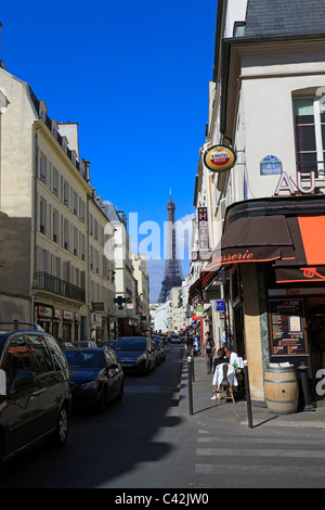 Rue St Dominique, Paris. The Eiffel Tower can be seen over the rooftops of this busy one way street in the 7th arrondissement.