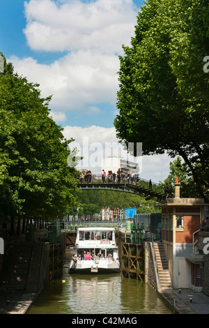 PARIS, FRANCE - MAY 08, 2011:  Canauxrama Boat in lock on canal St-Martin in summer Stock Photo