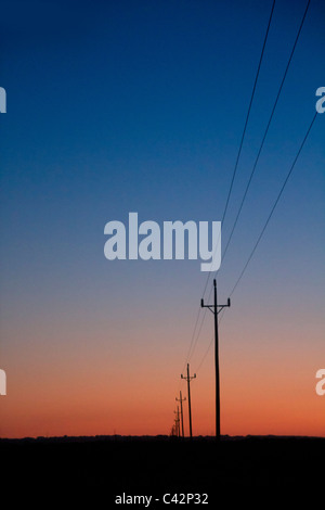 electric power lines in sunset blue red orange sunrise Stock Photo