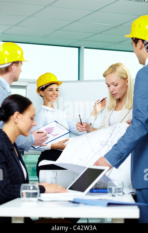 Group of architects sharing ideas in office Stock Photo