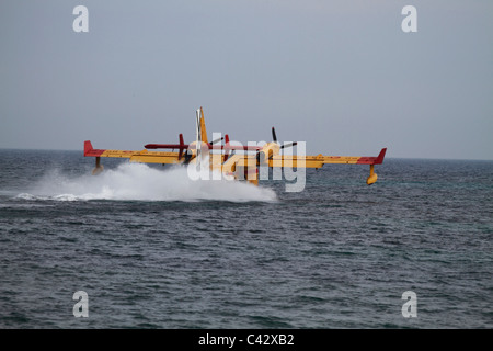 Canadair CL-145 firefighting plane tanking water Stock Photo