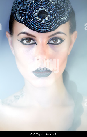 Gorgeous woman with bright makeup looking at camera Stock Photo