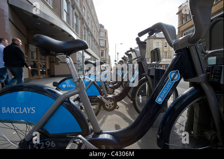 A row of Barclays sponsored bicycles line up on the pavement of a street in Basyswater, London. (Editorial use only). Stock Photo