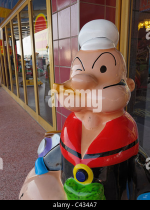 A 'Popeye the Sailor Man' figure outside the funfair at Clarence Pier, Southsea, Portsmouth, England. Stock Photo