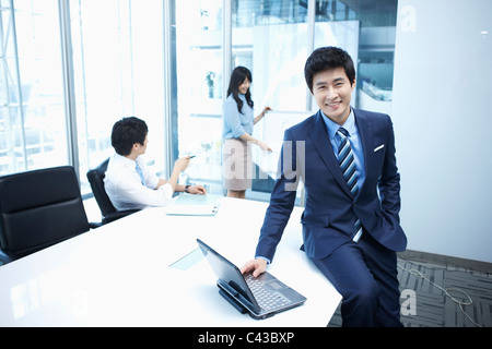 woman doing presentation to people in meeting room Stock Photo